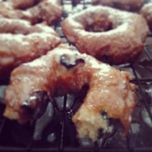 Gluten-free blueberry cake doughnut recipe. These are the best gluten-free donuts I've ever had! Crunchy outside, with a soft cakey inside, bursting with fresh blueberries and finished off with a sweet glaze. Yum!