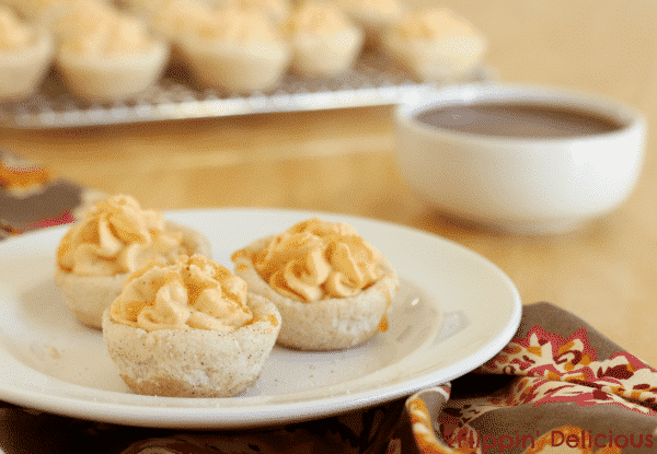 Gluten free snickerdoodle cookie cups are soft and chewy, with all the sweetness and spiciness of a traditional snickerdoodle cookie. Filled with creamy pumpkin mousse and drizzled with just a touch of sweet salted caramel sauce they taste like the pumpkin pie from your dreams.