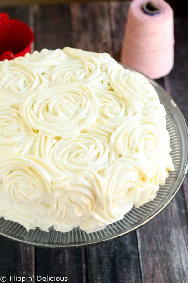 Step-by-step photos make stacking three layers of gluten free red velvet cake piped w/ fluffy rosettes a 