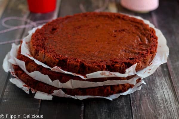 Step-by-step photos make stacking three layers of gluten free red velvet cake piped w/ fluffy rosettes a 