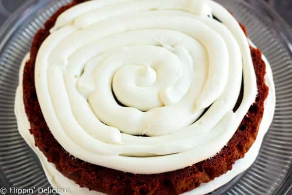 Step-by-step photos make stacking three layers of gluten free red velvet cake piped w/ fluffy rosettes a 