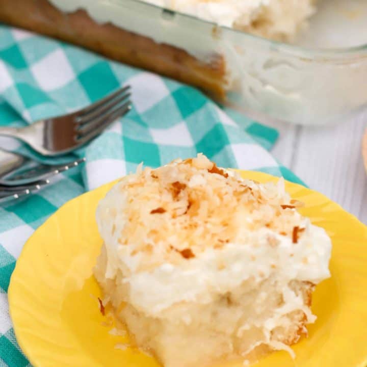 Gluten free coconut poke cake made with white cake, cream of coconut poured over the top, and topped with whipped cream and toasted coconut. So many layers of coconut flavor!