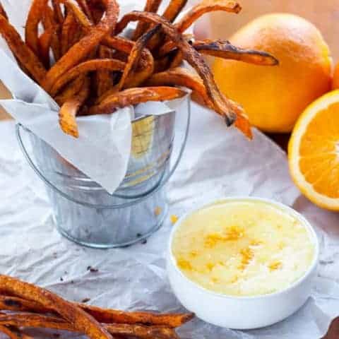 Crispy Baked Sweet Potato Fries with Orange Zest Icing Dipping Sauce. Crispy edges, velvety soft insides and a bright orange citrus icing to dip or drizzle on your fries however you want! Naturally gluten free and dairy free.