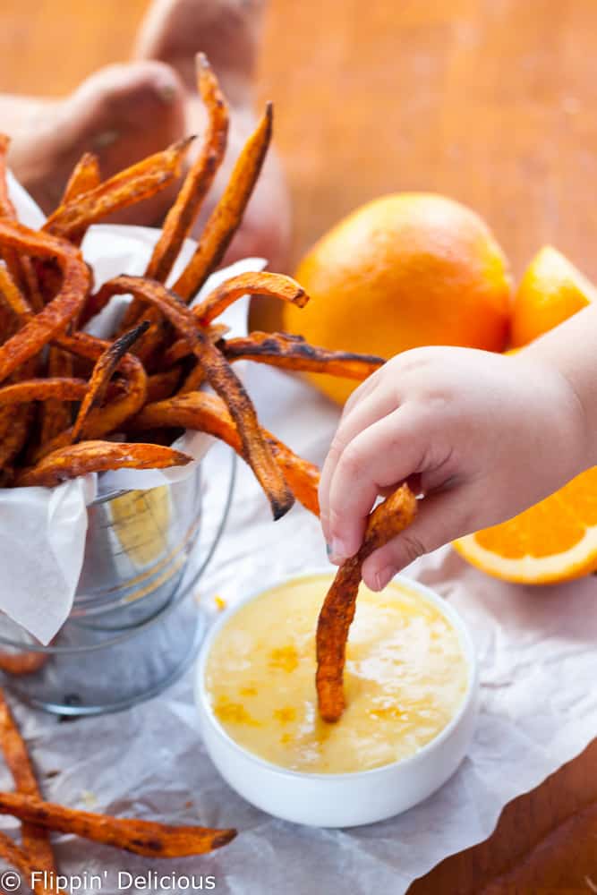 Crispy Baked Sweet Potato Fries with Orange Zest Icing Dipping Sauce. Crispy edges, velvety soft insides and a bright orange citrus icing to dip or drizzle on your fries however you want! Naturally gluten free and dairy free.