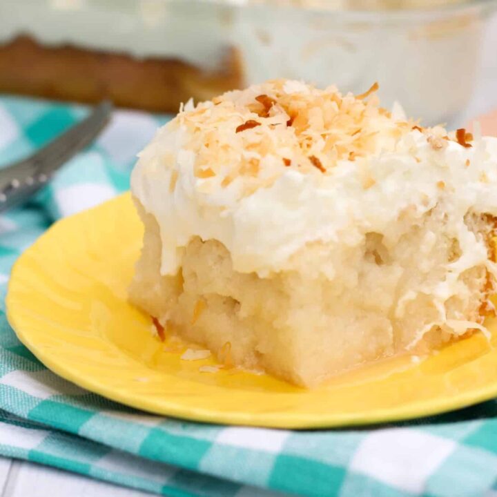 Gluten free coconut poke cake made with white cake, cream of coconut poured over the top, and topped with whipped cream and toasted coconut. So many layers of coconut flavor!