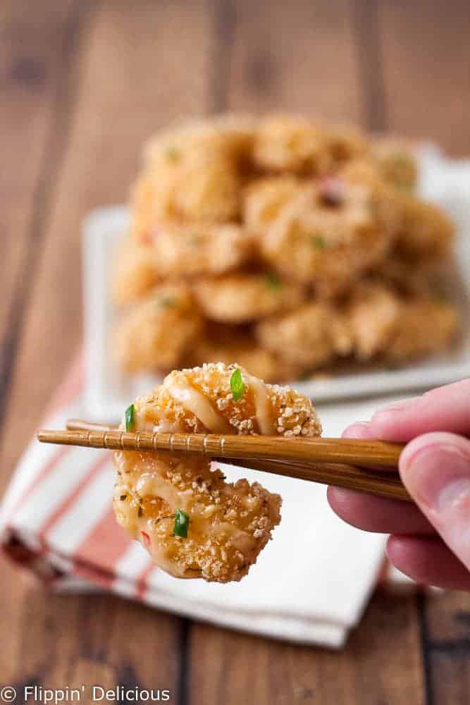 gluten free fried ban bang shrimp being held ith chopsticks