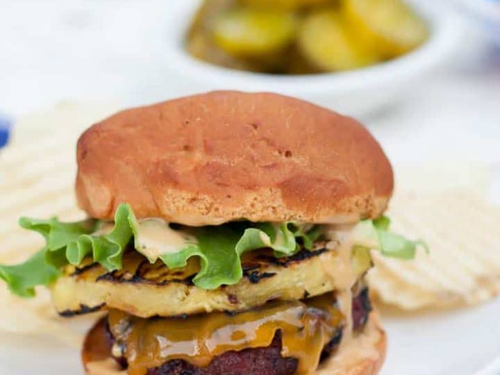 Gluten free teriyaki grilled pineapple burgers are the perfect twist for your next summer barbecue! Juicy beef hamburger patties rubbed with ginger-brown sugar rub, fresh grilled pineapple slices, and a creamy teriyaki mayo will make your mouth water!