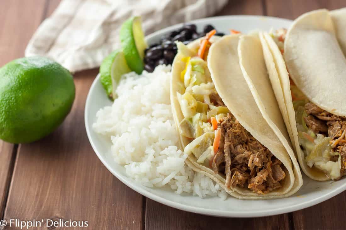 Gluten free pulled pork with green chile slaw is a flavor bomb in your mouth! Use it for tacos, sandwiches, salads… anything!