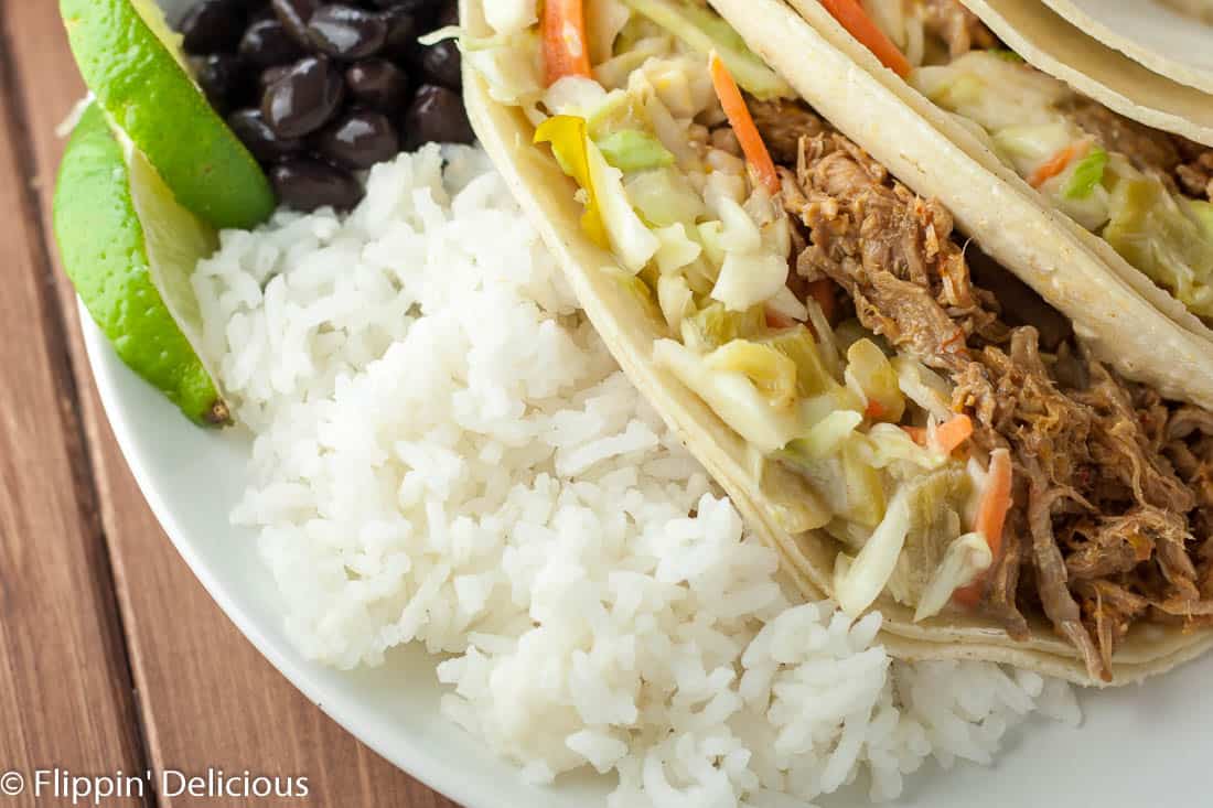 Gluten free pulled pork with green chile slaw is a flavor bomb in your mouth! Use it for tacos, sandwiches, salads… anything!