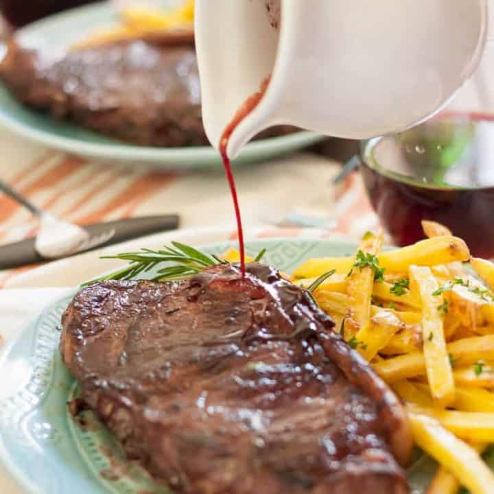 Juicy new york strip steaks marinated in red wine, rosemary, garlic and shallots with garlic and herb baked fries make a perfect at home date!