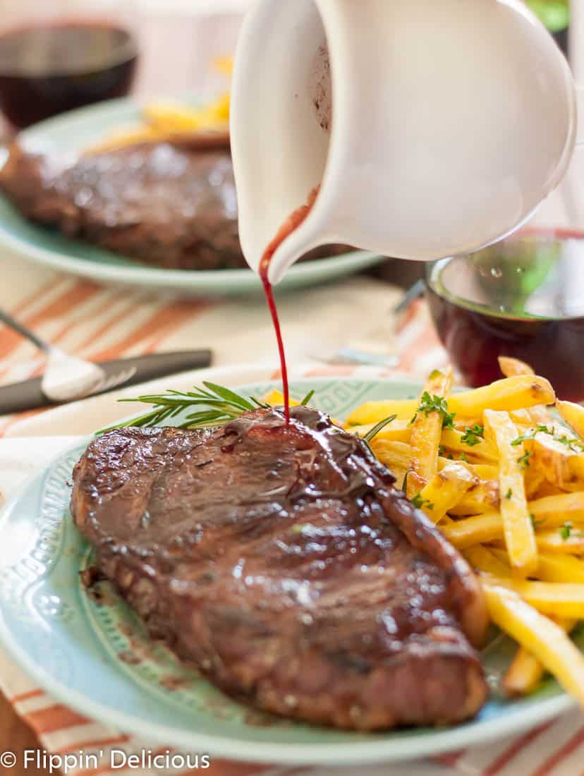 Juicy new york strip steaks marinated in red wine, rosemary, garlic and shallots with garlic and herb baked fries make a perfect at home date!