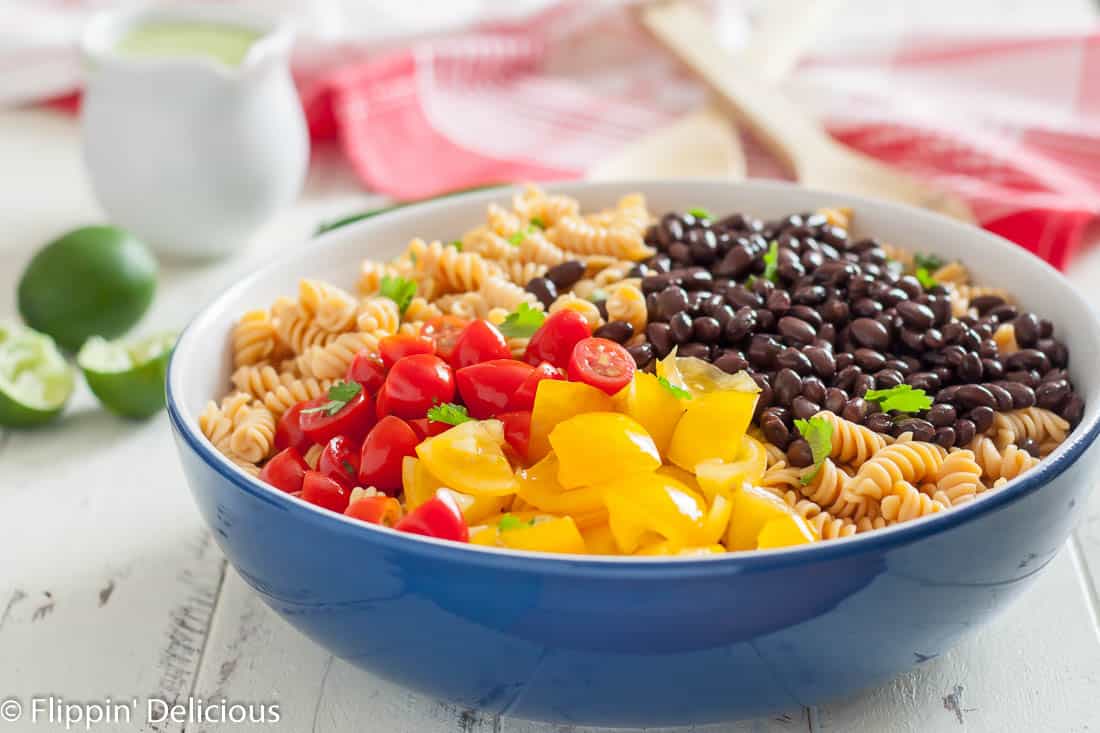 Gluten free southwest pasta salad has a kick you won’t get from a regular pasta salad! It’s perfect for summer potlucks.