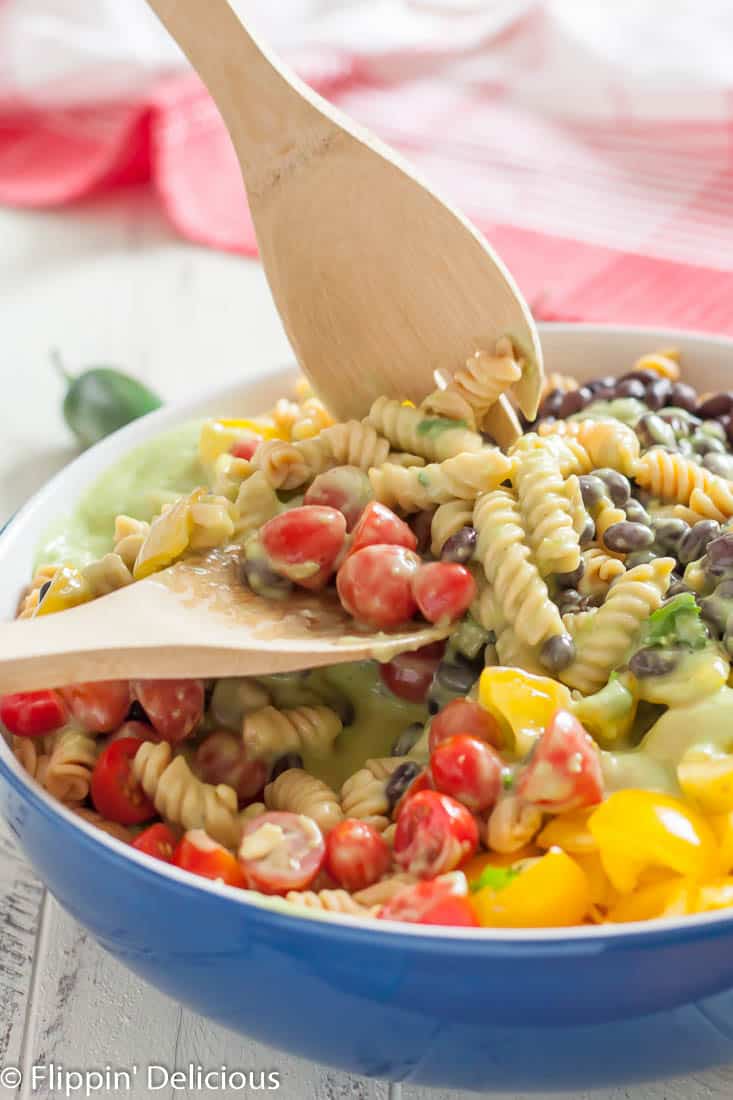 Gluten free southwest pasta salad has a kick you won’t get from a regular pasta salad! It’s perfect for summer potlucks.