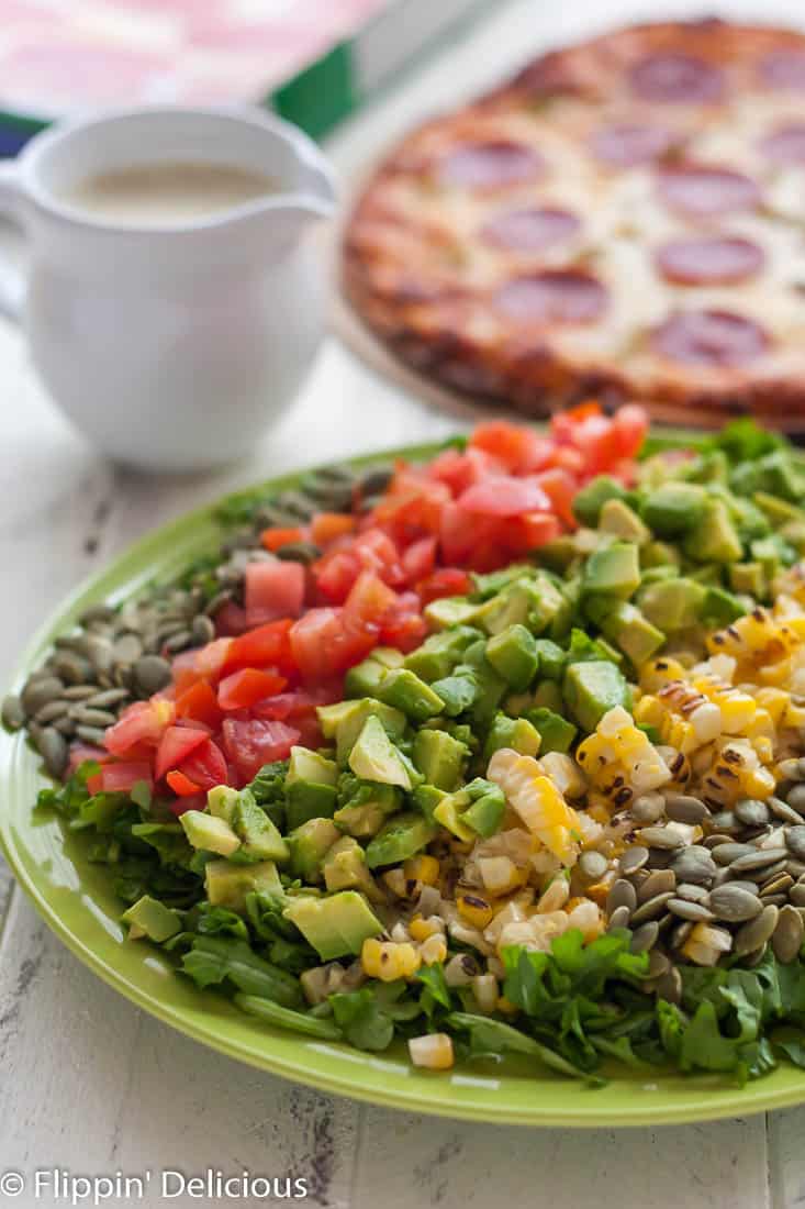 This New Mexican Chopped Salad with Hatch Green Chile Vinaigrette makes the perfect weeknight meal when combined with gluten free green chile pepperoni pizza!