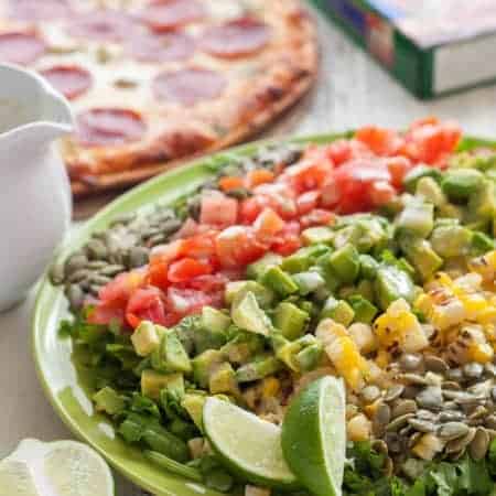 This New Mexican Chopped Salad with Hatch Green Chile Vinaigrette makes the perfect weeknight meal when combined with gluten free green chile pepperoni pizza!