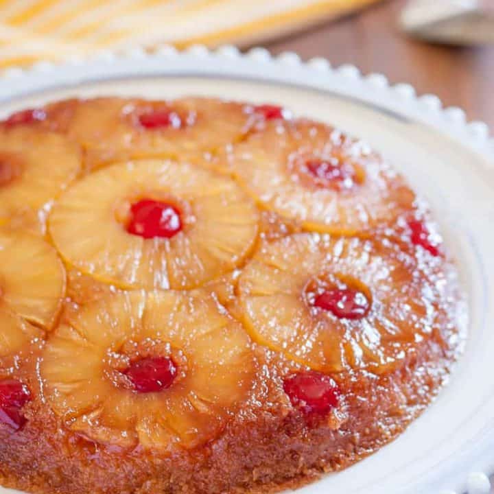 Gluten Free Pineapple Upside Down Cake is a classic dessert with gooey brown sugar, pineapple rings, and cherries. Dairy free option!