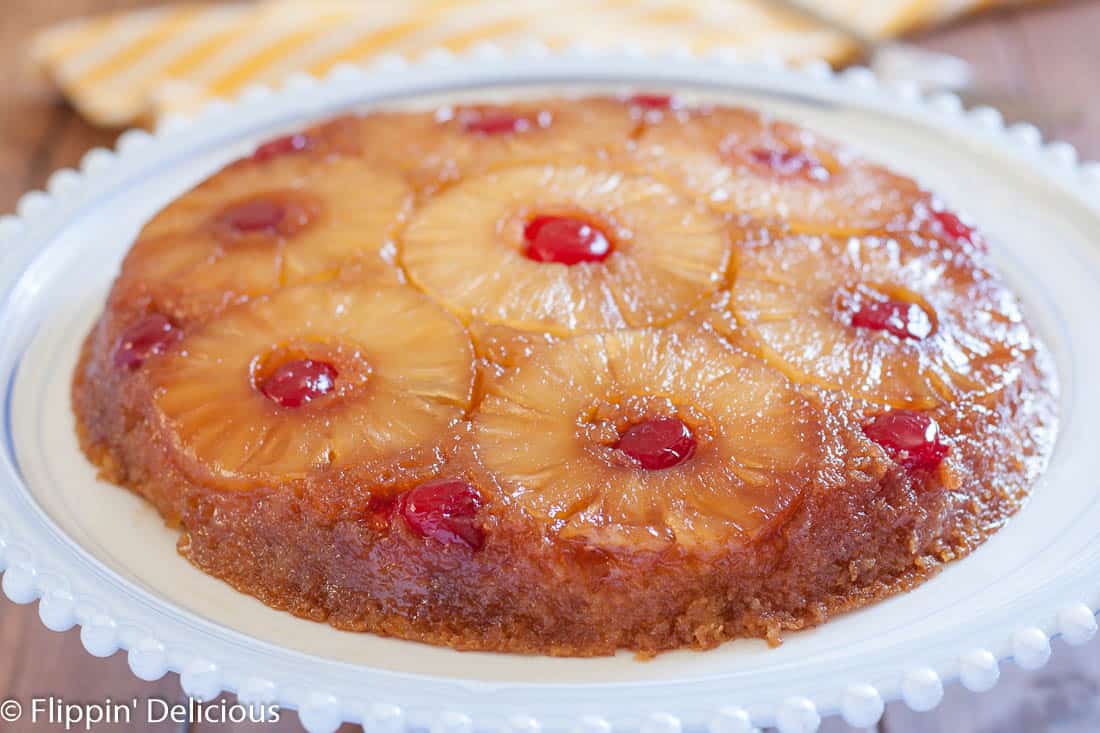 Gluten Free Pineapple Upside Down Cake is a classic dessert with gooey brown sugar, pineapple rings, and cherries. Dairy free option!