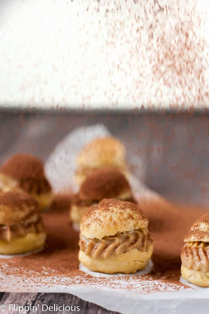 Gluten free tiramisu cream puffs have all the flavors and textures of the classic Italian dessert in a fun bite-sized dessert. The perfect pick-me-up!