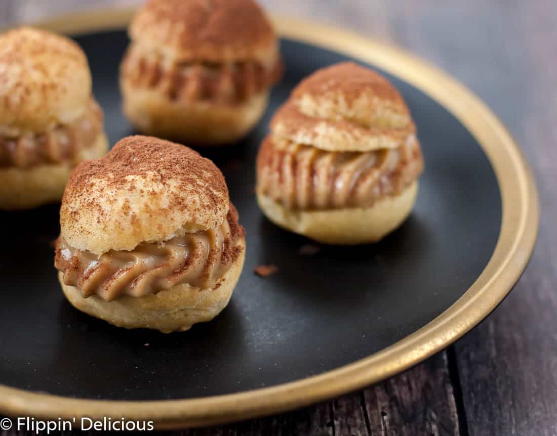 Gluten free tiramisu cream puffs have all the flavors and textures of the classic Italian dessert in a fun bite-sized dessert. The perfect pick-me-up!