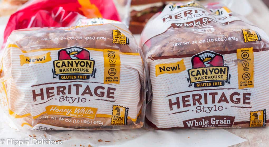 two loaves of canyon bakehouse gluten free bread side by side, heritage style honey white gluten free bread and heritage style gluten free whole grain bread