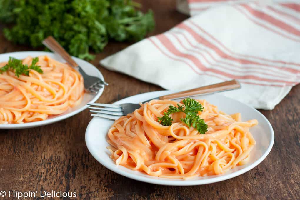 Vegan Roasted Red Pepper Alfredo, gluten-free and dairy-free, is an easy weeknight meal that the entire family can enjoy. With minimal prep, the sauce is ready before the pasta is finished cooking! 