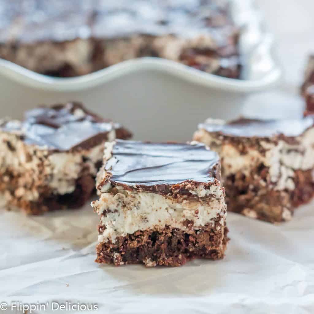 three gluten free cookie and cream brownies on a piece of parchment paper