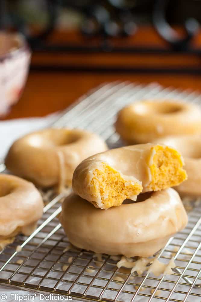 Tender gluten-free pumpkin donuts with maple glaze make the perfect allergy-friendly fall treat!