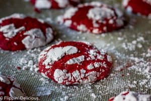 Gluten Free Red Velvet Crinkle Cookies are soft and cakey, with hints of real cocoa and vanilla. Covered in sweet powdered sugar, they make a fun and festive cookie.
