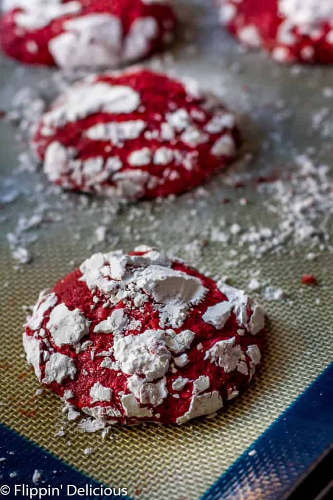 Gluten Free Red Velvet Crinkle Cookies are soft and cakey, with hints of real cocoa and vanilla. Covered in sweet powdered sugar, they make a fun and festive cookie.