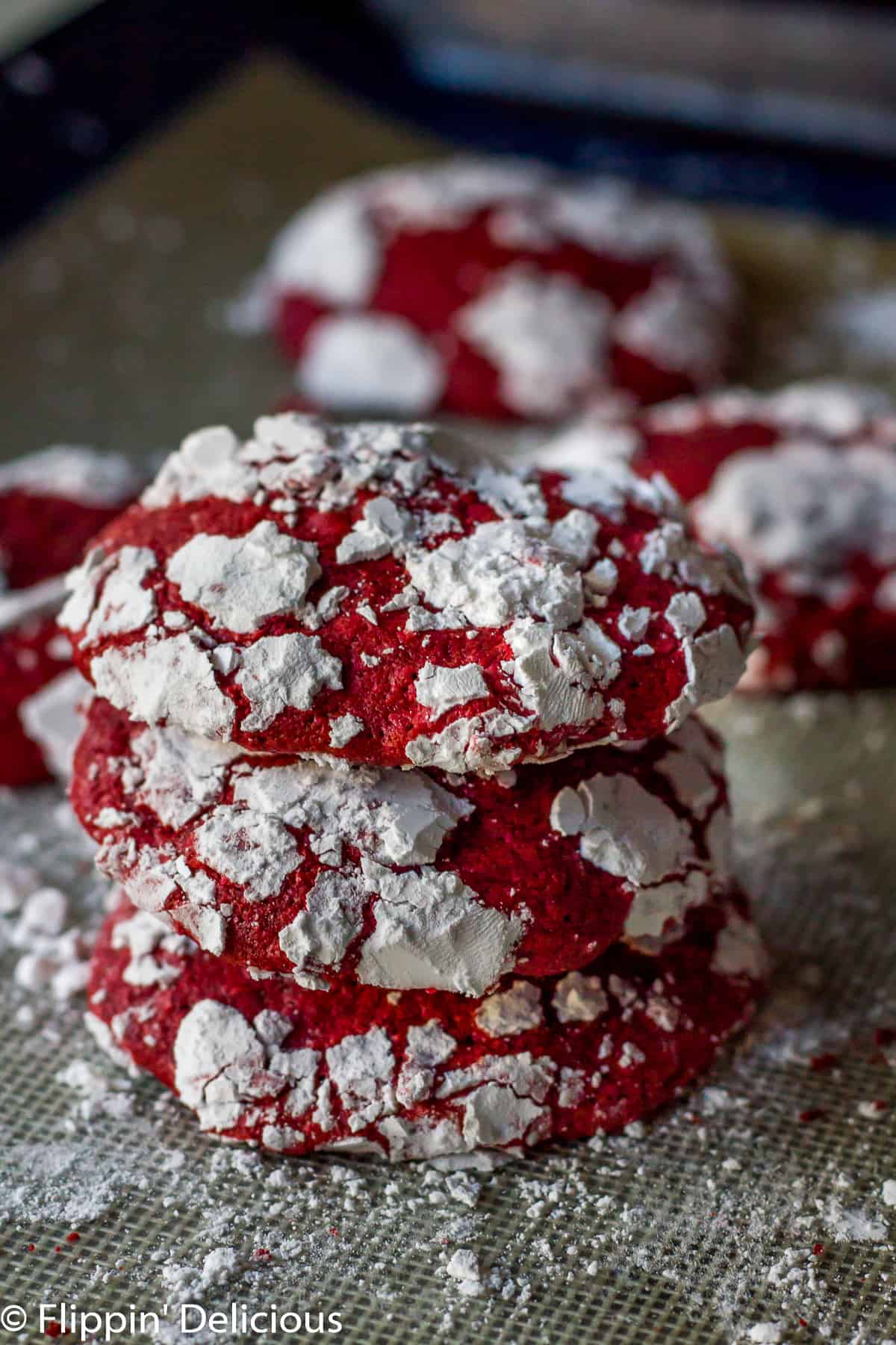 Gluten Free Red Velvet Crinkle Cookies are soft and cakey, with hints of real cocoa and vanilla. Covered in sweet powdered sugar, they make a fun and festive cookie.