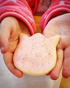 gluten free pink tulip sugar cookie from Sweet Nothings in the hands of young girl