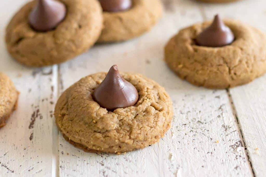 Gluten free blossom cookies made with sunflower seed butter cookies with hershey's kiss on a white farmhouse table