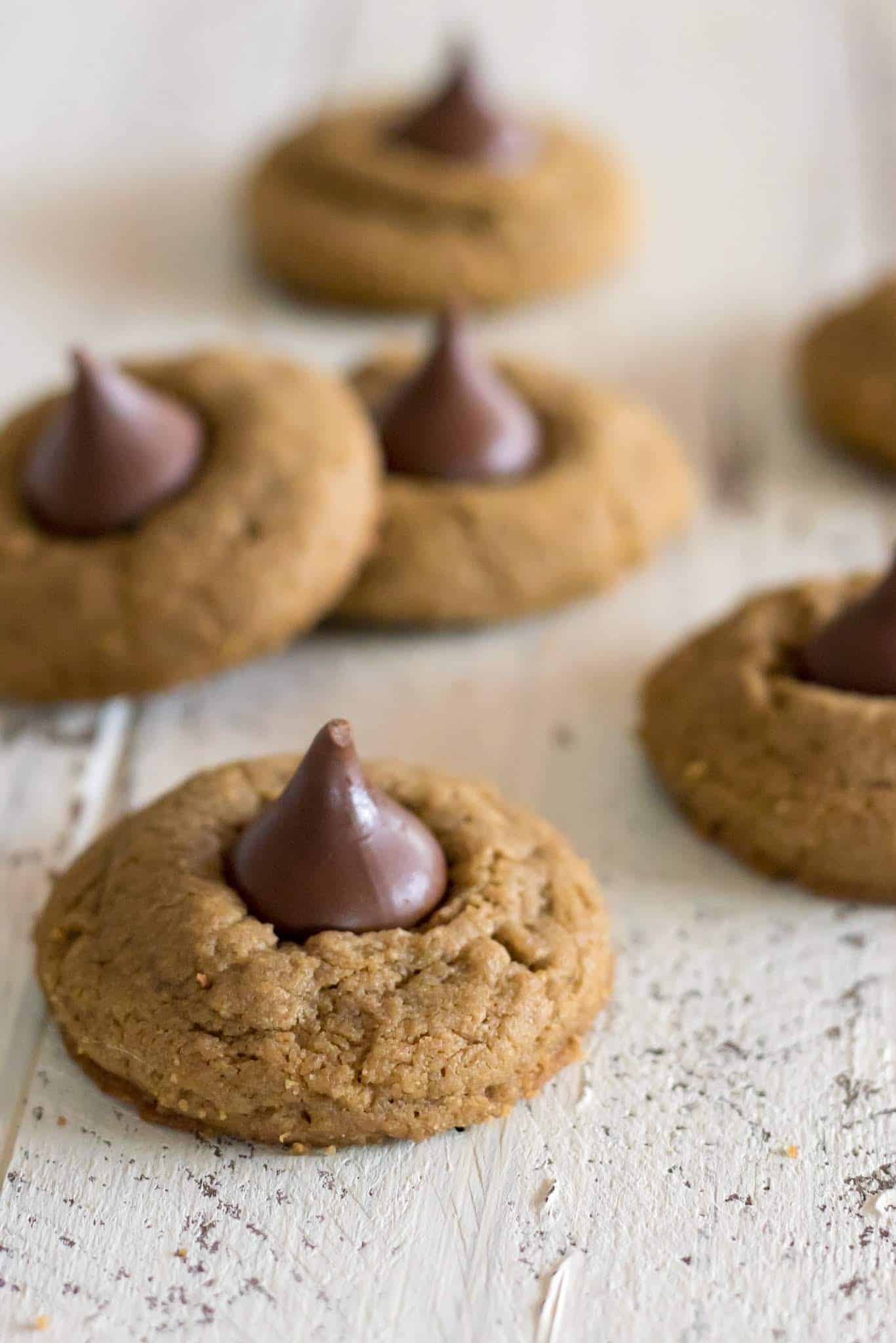 Gluten free blossom cookies made with sunflower seed butter cookies with hershey's kiss on a white farmhouse table