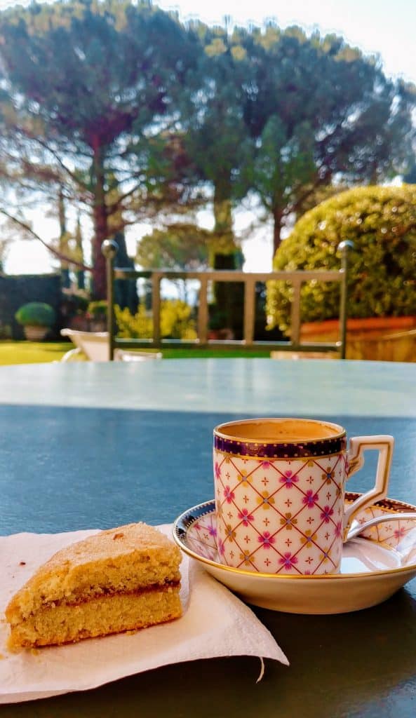 drinking espresso and a gluten free scone at villa boccella, overlooking gardens 