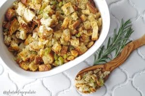 gluten free stuffing with celery and onions in a white casserole dish