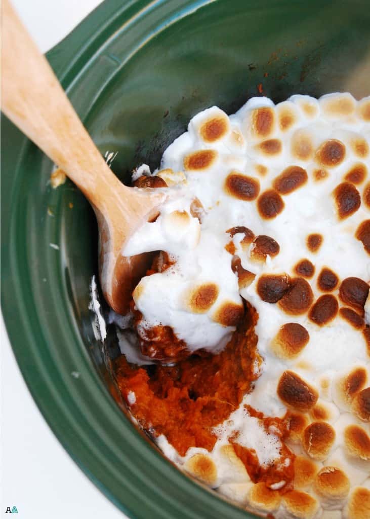 overhead view of slow cooker sweet potato casserole with toasted marshmallows on top