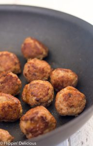 gluten free turkey meatballs browned and sitting in nonstick skillet
