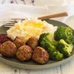 gluten free turkey meatballs on a green plate with broccoli and mashed potatoes