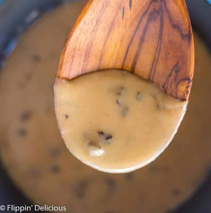 wooden spoon with gluten free cream of mushroom soup over saucepan 