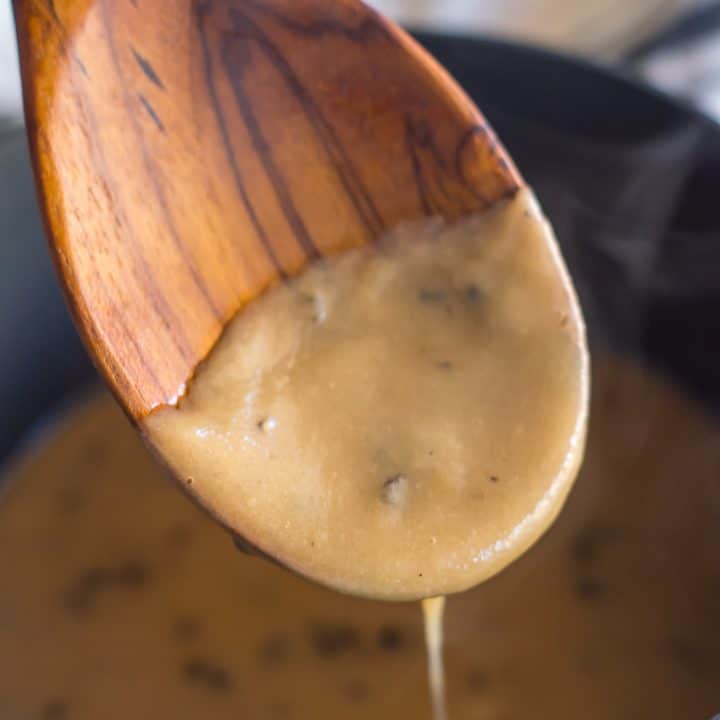 wooden spoon with gluten free cream of mushroom soup over saucepan