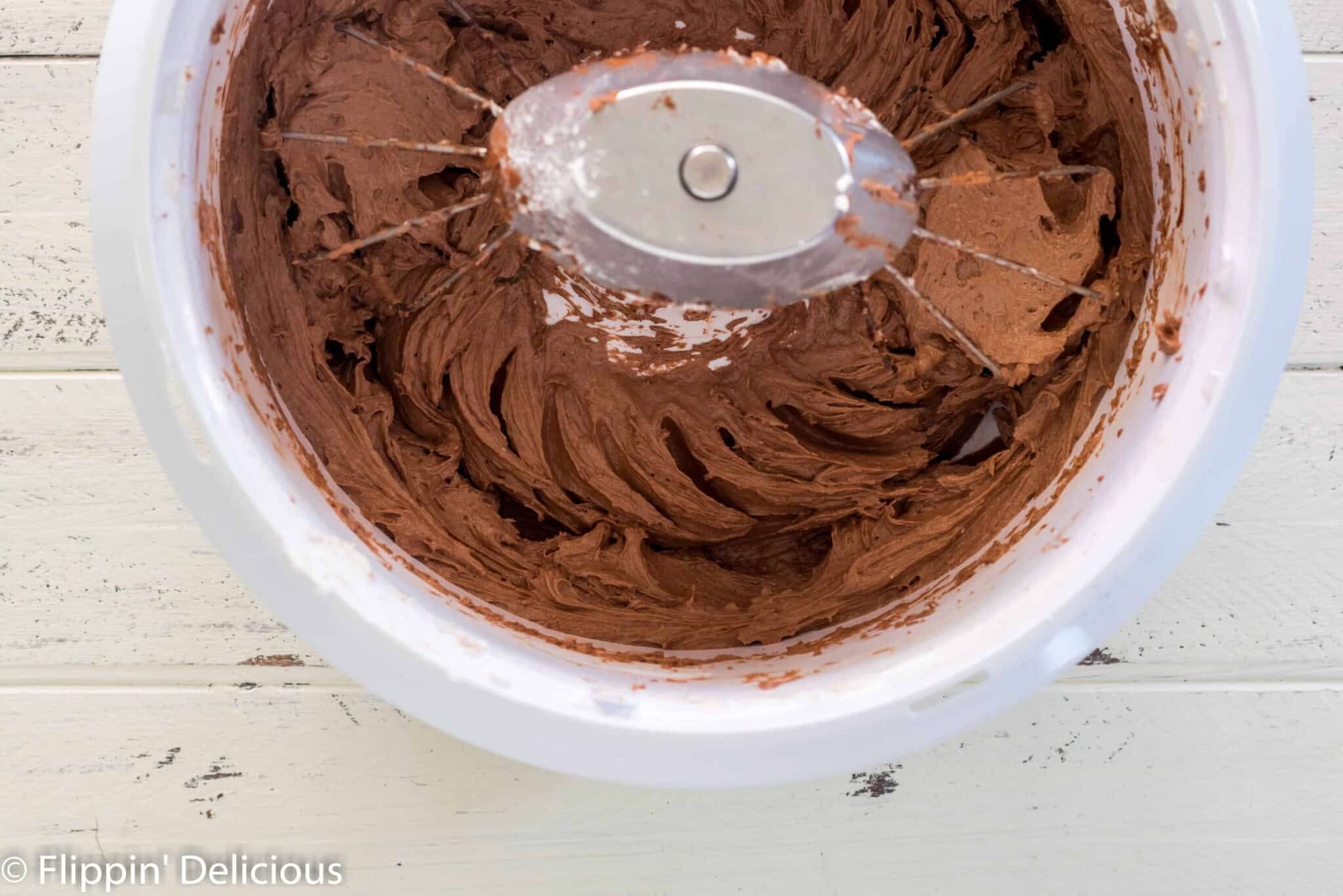 nutrimill mixer full of fluffy vegan chocolate buttercream