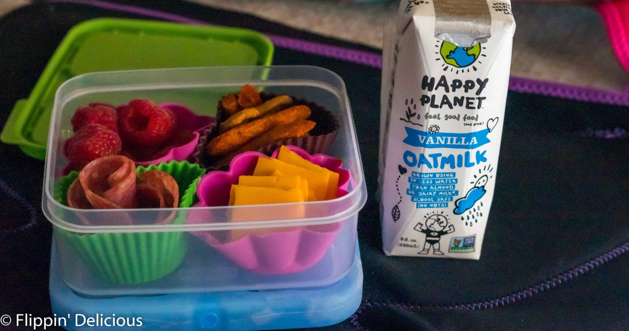 kids lunchbox container packed with nut free dairy free gluten free lunch and a dairy free oat mylk container