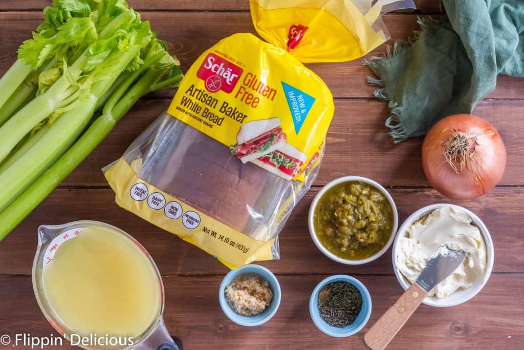 ingredients to make gluten free stuffing with hatch green chile, celery, green chile, herbs, broth, spices, butter, onion, and schar gluten free artisan baker white bread