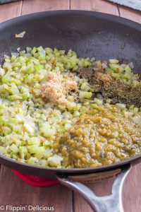 sauteed celery and onions in a skillet, with minced garlic, herbs, and green chile just added