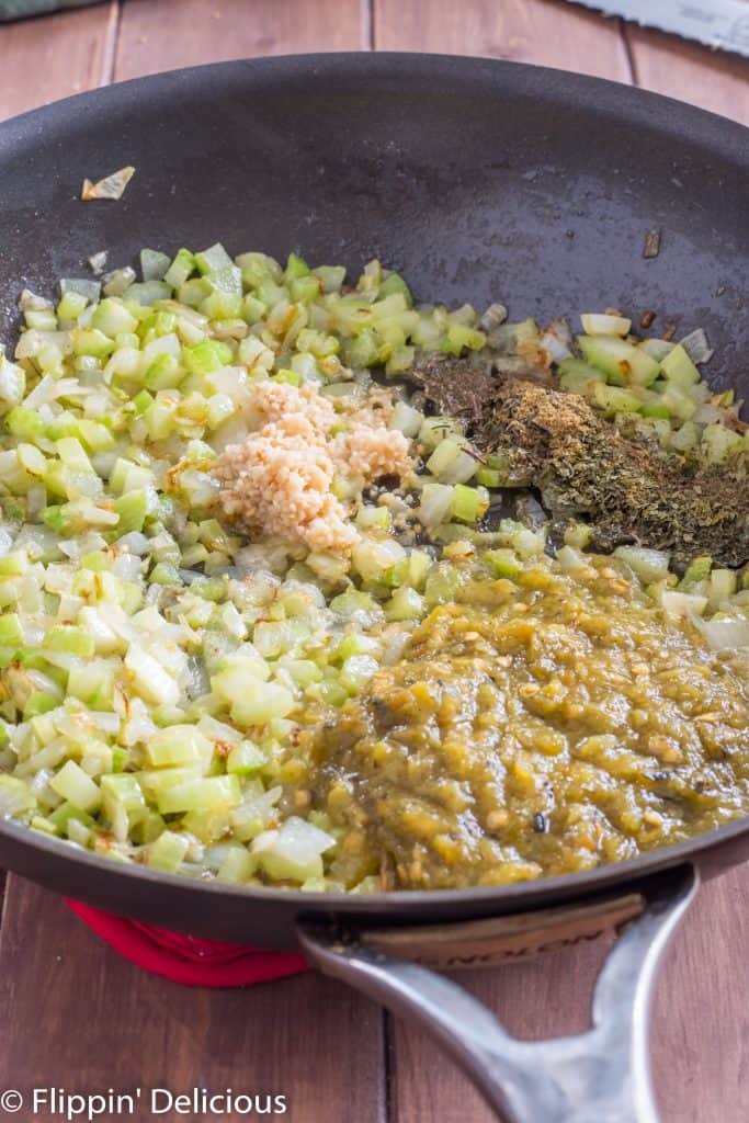 sauteed celery and onions in a skillet, with minced garlic, herbs, and green chile just added