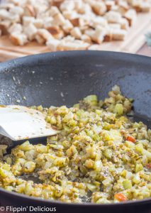 skillet with sauteed onion, garlic, green chili, celery, herbs, and butter