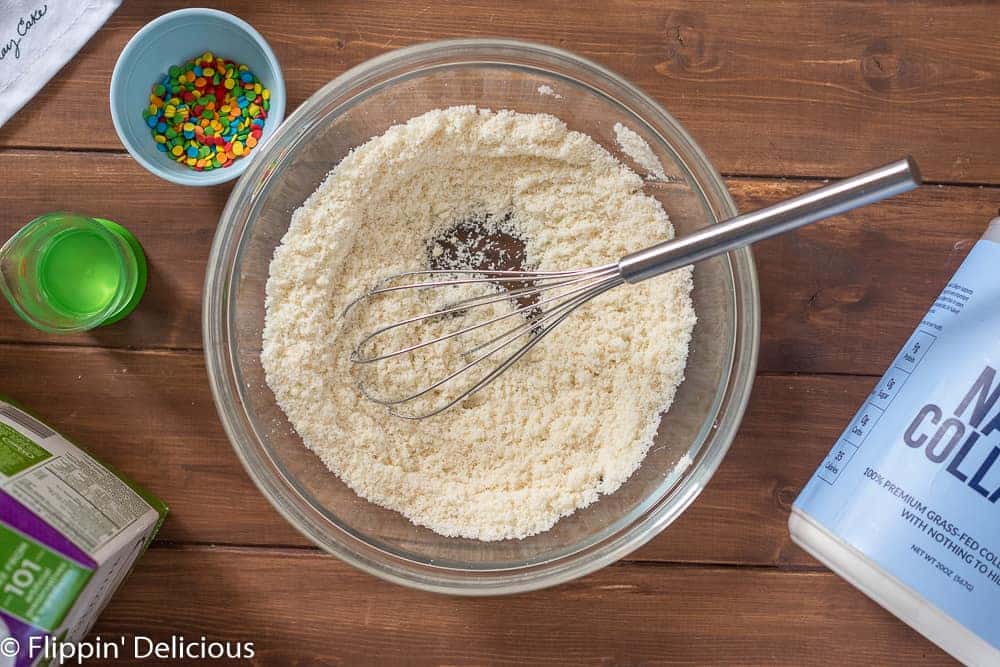 dry ingredients for cookie dough keto protein bites, almond flour, granulated keto sweetener, and collagen peptides, whisked til combined