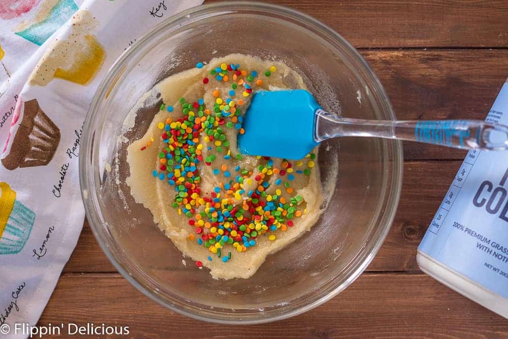 Adding sprinkles to keto sugar cookie protein bite dough to make low carb protein bites