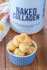 bowl of keto sugar cookie dough energy balls with naked collagen peptides package in the background