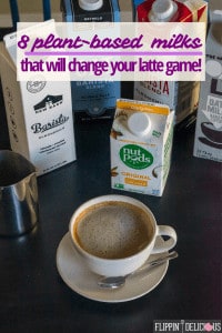 text "8 plant-based milks that will change your latte game" over picture of dairy free latte in small latte mug with a stainless steel pitcher and cartons of dairy free barista milk in the background including NutPods, The New Barn, Califia Farms,and Oatly